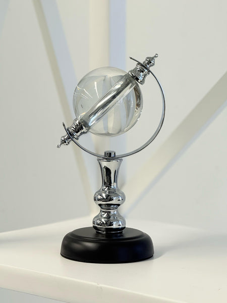 Sleek silver crystal globe on black base for elegant home styling.