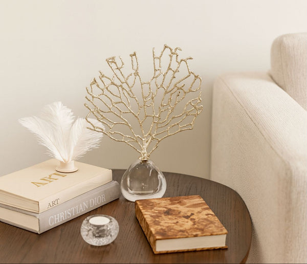 crystal tree decor setting with books and a decorative piece on a table.