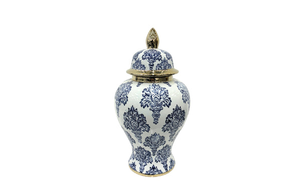 Large blue and white damask ceramic urn with gold lid and base detailing.