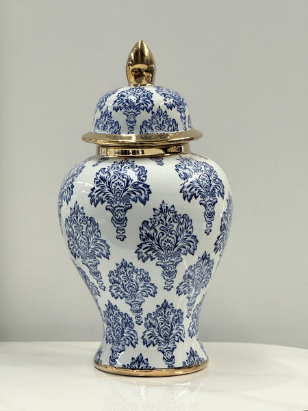  Elegant blue and white damask ceramic urn with gold accents styled for display.