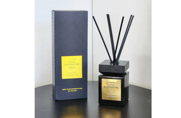 Encounter Diffuser 200ml in black bottle with gold label and matching black box, elegantly displayed on a dark surface – a luxurious home fragrance option.