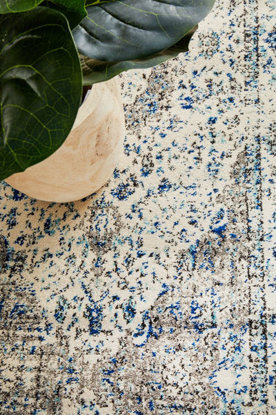 Close-up of the Evoke 21 White Rug showing detailed weave and soft polypropylene texture in white, blue, and grey tones.