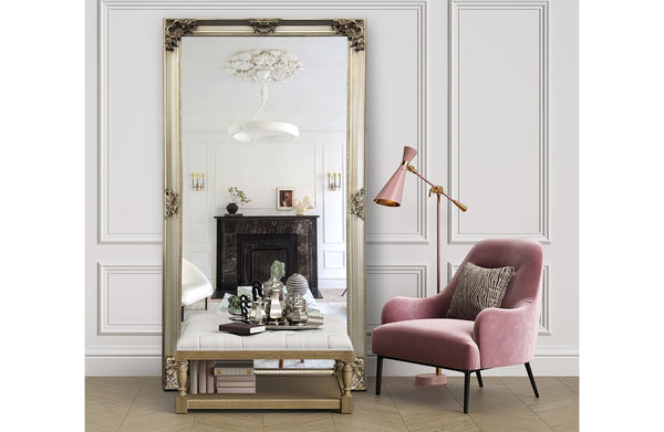 Champagne French provincial deluxe mirror styled with pink armchair, fireplace and elegant décor accents.