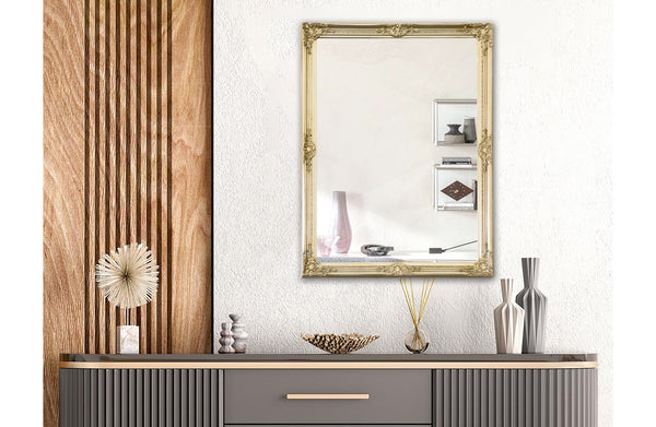 Gold French provincial ornate mirror styled above black console table with golden wall lights.
