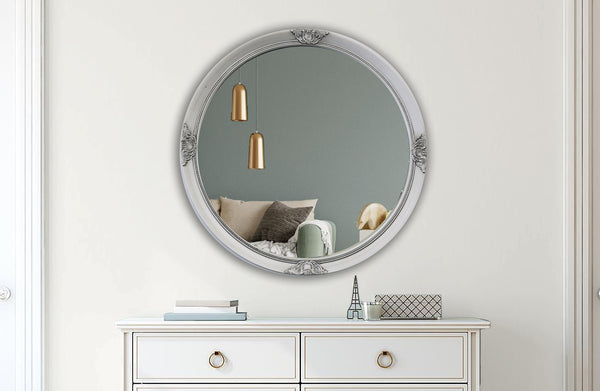 Silver French provincial round mirror styled with wooden console, candles and festive greenery.
