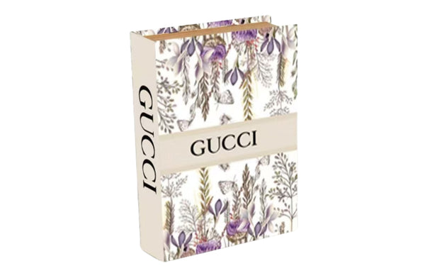 Large floral faux book storage box with white base and purple flower design and hidden compartment.