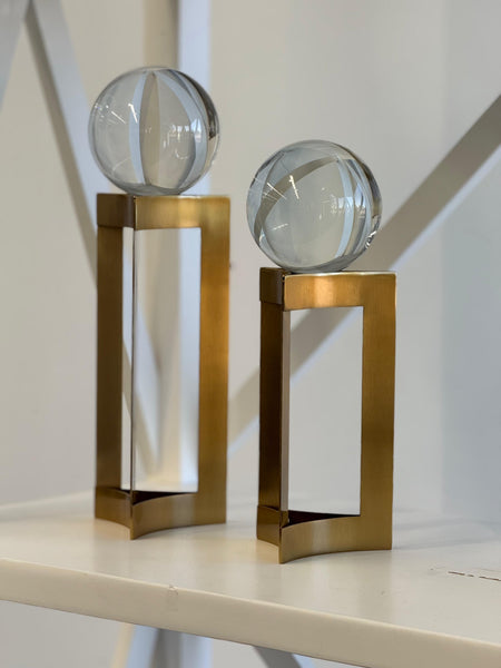 Gold glass sphere décor pair styled with elegant modern home interior.