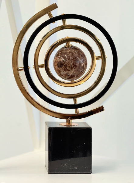 Black and gold globe décor styled on a surface, radiating elegance and modern charm.