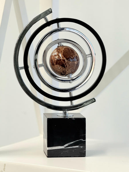 Black and silver globe décor in a room setting, adding a sleek contemporary touch.