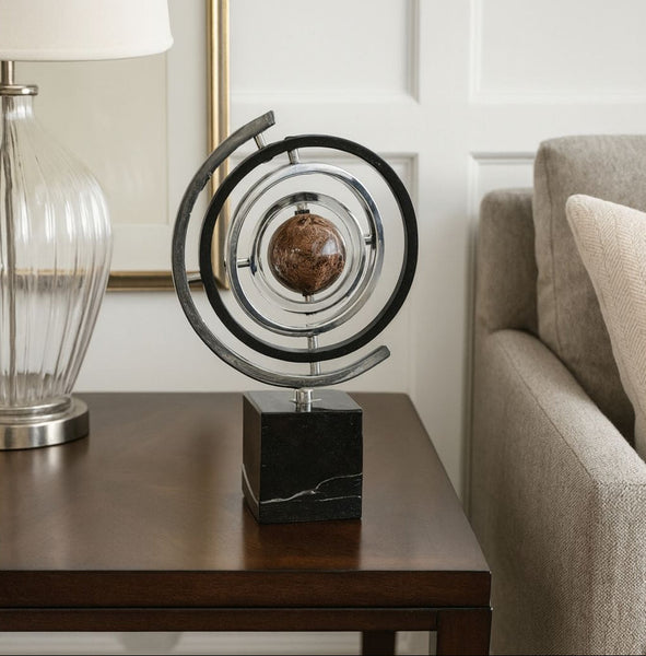 Decorative globe table decor on a table next to a lamp and sofa