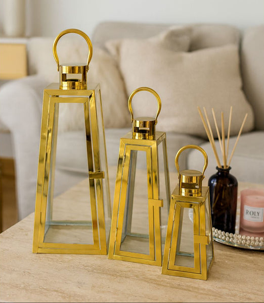 gold pyramid lantern set styled on table modern home decor candle holders