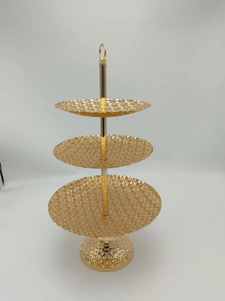 Elegant 3-tier gold cake stand with decorative base, ideal for showcasing cakes and treats.