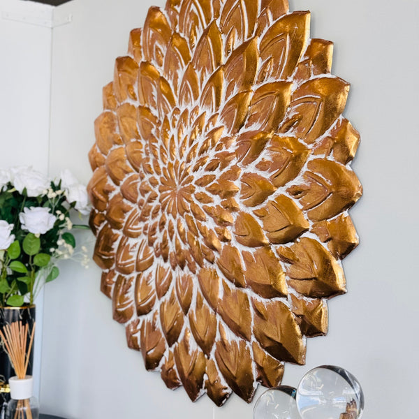 Side view of gold flower wall art highlighting textured petals and layered design.