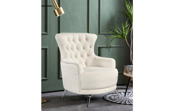 GRAND beige velvet tufted wing chair with silver legs styled in modern interior