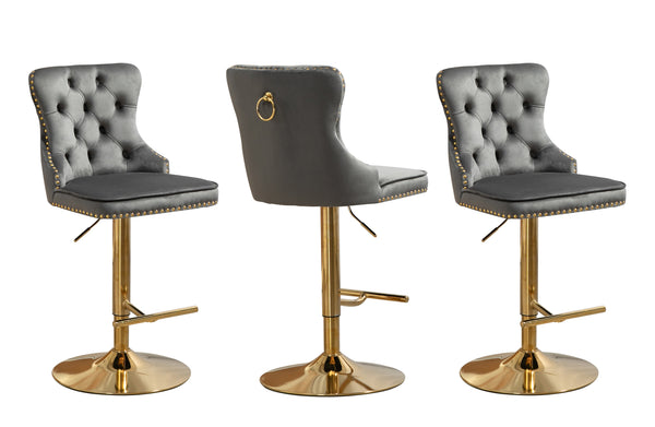 Stylish grey velvet tufted swivel bar stool with stud trim and polished gold stand.