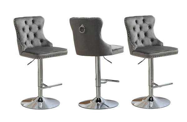 Contemporary grey velvet tufted swivel bar stool with stud trim and silver stand.