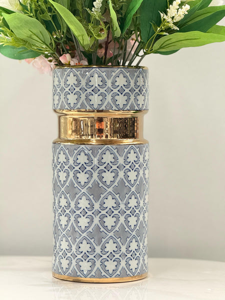 Stylish Greyson vase in gold, white, and grey, beautifully displaying fresh green florals.