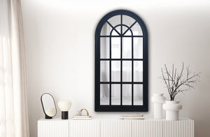 Large black Hampton’s Arch Window Mirror styled above white sideboard in living room