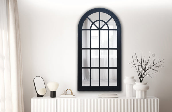 Large black Hampton’s Arch Window Mirror styled above white sideboard in living room
