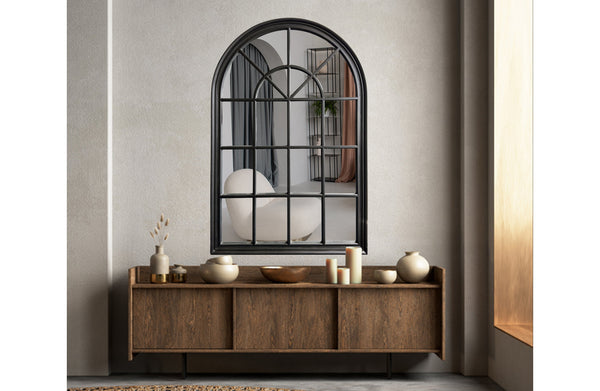 Small black Hampton’s Arch Window Style Mirror styled above console table in living area