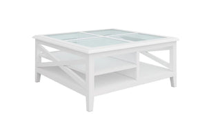 Hampton’s style white timber and glass coffee table with storage shelf, studio image.