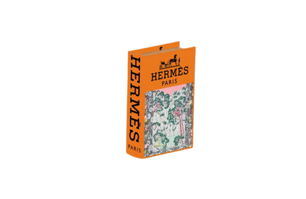 Small orange faux book storage box ideal for shelf styling or bedside decor with hidden storage.