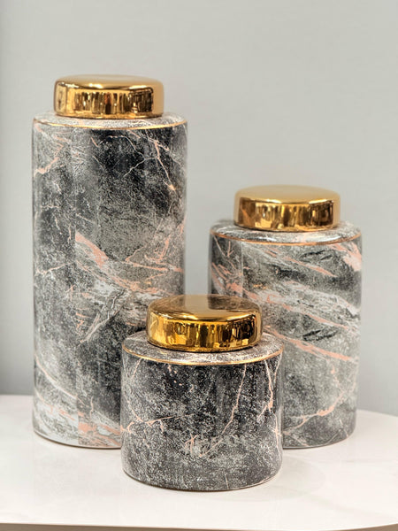 Stylish black and gold ceramic canisters styled for modern interiors.