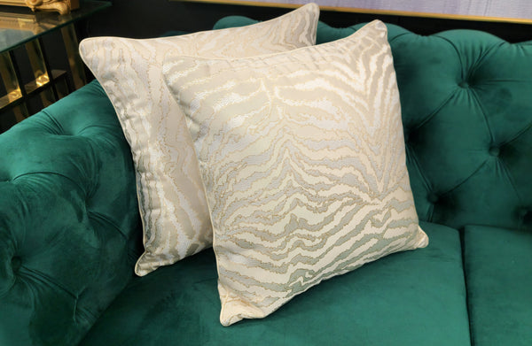 Earthy-toned designer cushion with rich textured fabric, perfect for adding warmth to beds and sofas