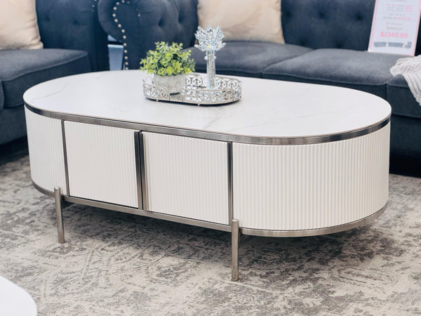 Kingsley white coffee table with silver trim styled with sofas