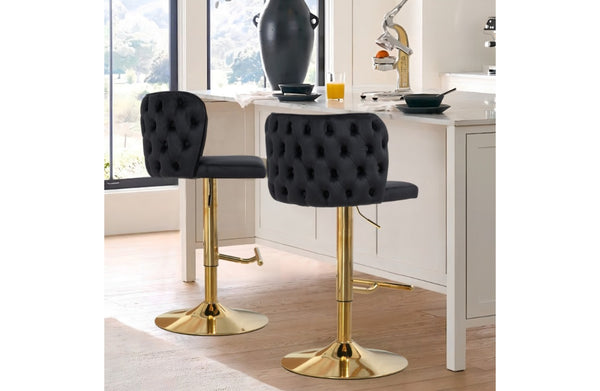 Lara black velvet tufted swivel bar stools with polished gold base in luxury kitchen