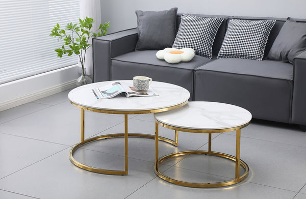 Layla nesting coffee table large set with polished gold frame and marble tops in modern setting.