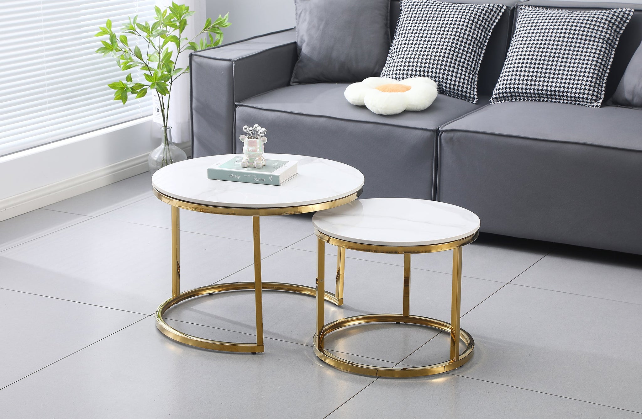 Layla nesting coffee table small set with gold polished frame and marble tops, styled in lounge.