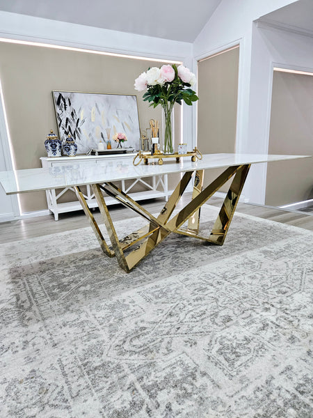 Lenox Dining Table gold frame with white marble top styled in luxury dining room.