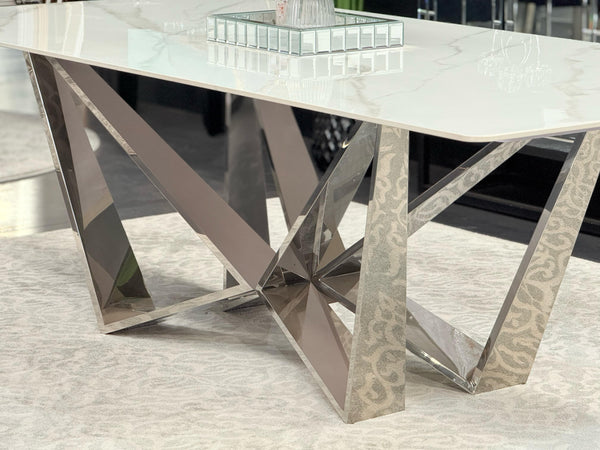 Close-up of Lenox Dining Table polished silver frame with white marble top surface.