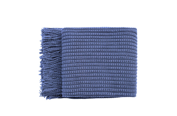 Levi Throw Rug Blanket in deep blue, folded neatly with textured weave and fringe edges.