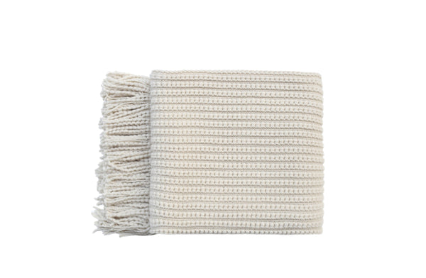 Levi Throw Rug Blanket in cream, neatly folded to showcase its soft, textured fabric and fringe.