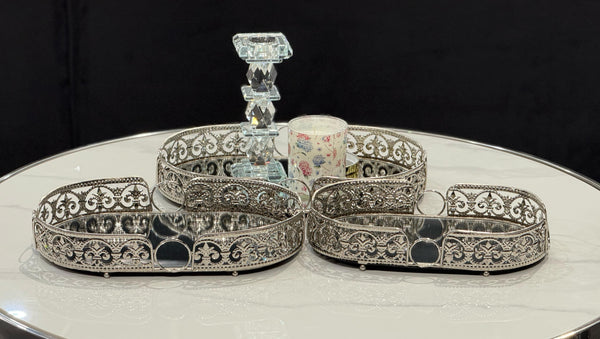 Sophisticated silver Lucy trays arranged beautifully with a mirrored base and floral accents for refined décor styling.