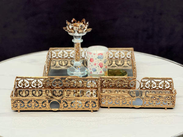 Set of gold rectangle Lucy trays styled with candles and decor – a perfect touch of opulence for your tabletop.