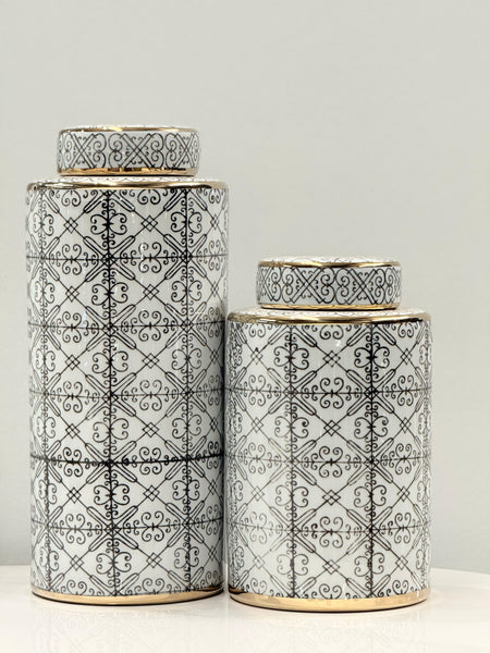 Chic ceramic canister set with intricate black patterns and gold accents, ideal for décor.