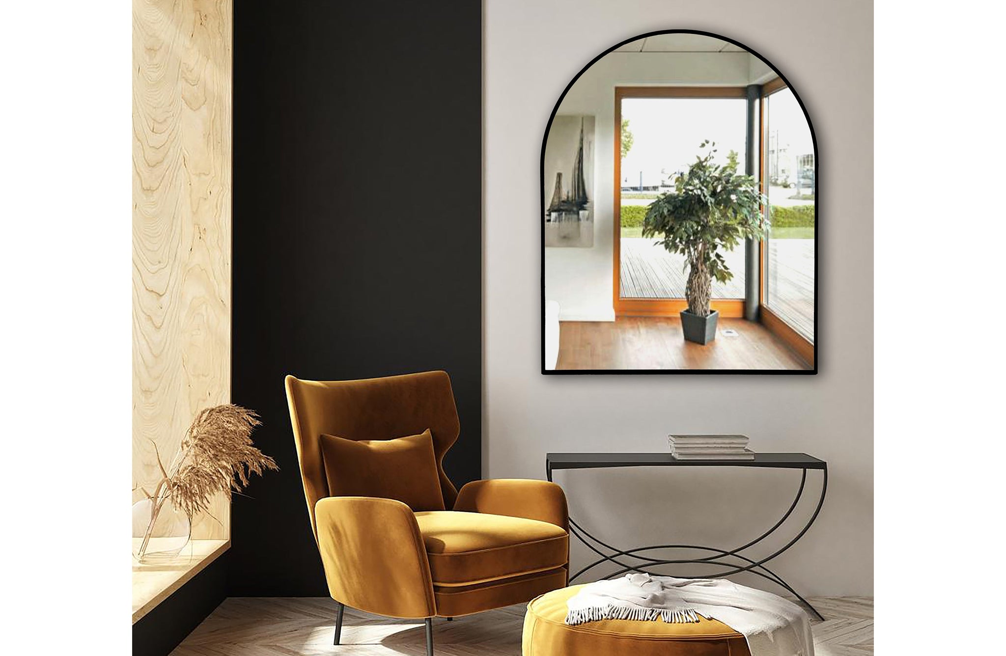 Small black metal arch mirror styled above console with mustard chair
