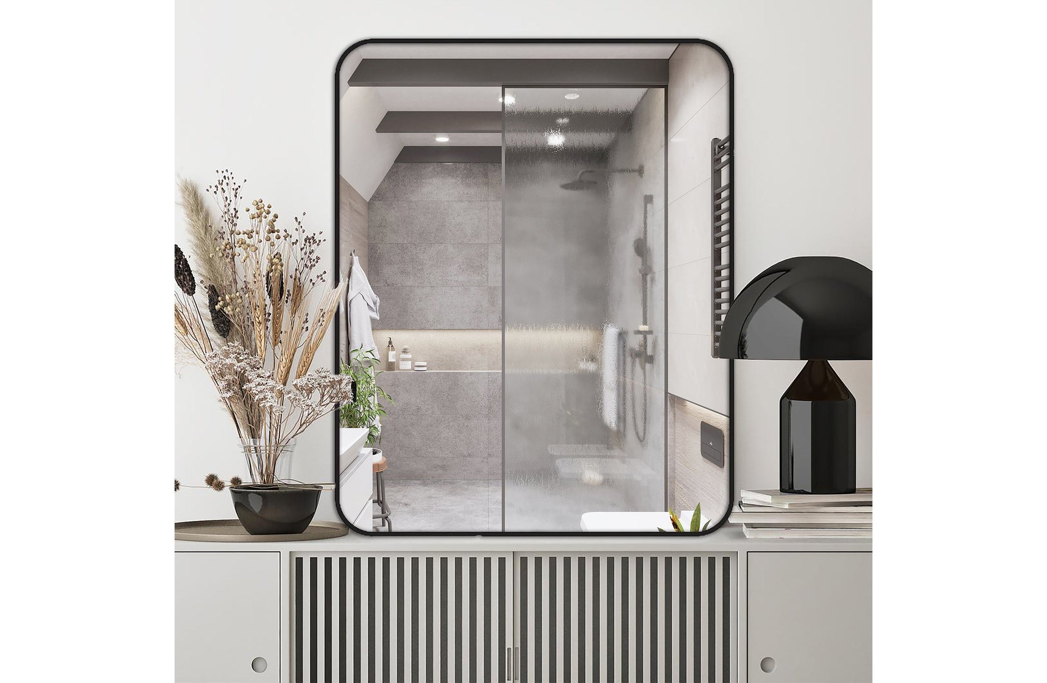 Small black metal rectangle mirror styled above console table in a bathroom vanity setting.