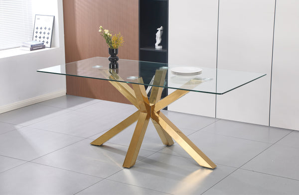 Miles rectangle dining table with polished gold frame and clear tempered glass top in a modern dining room.