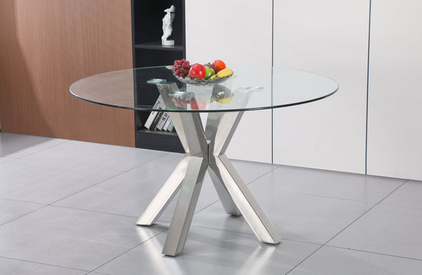 Miles round dining table with polished silver frame and clear glass top, styled with fruit décor.