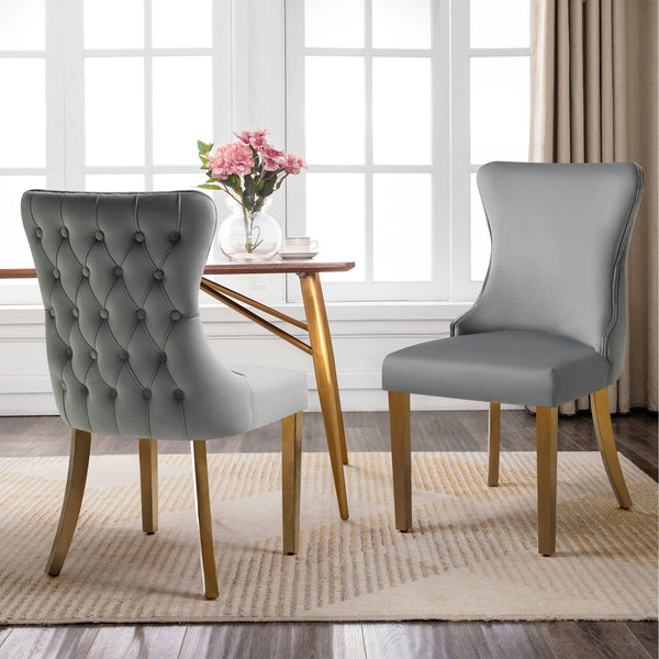 Grey velvet Paris dining chairs with gold legs styled around a round table, contemporary décor.