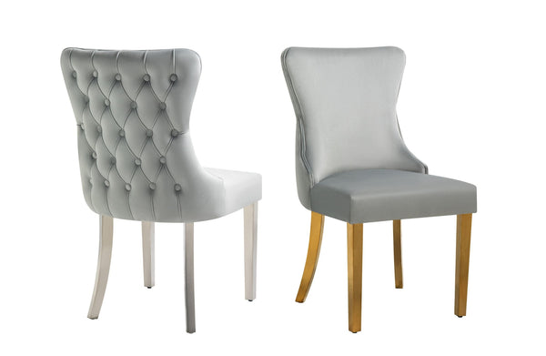 Light grey velvet Paris chairs, one gold-legged and one silver-legged, tufted back detailing.