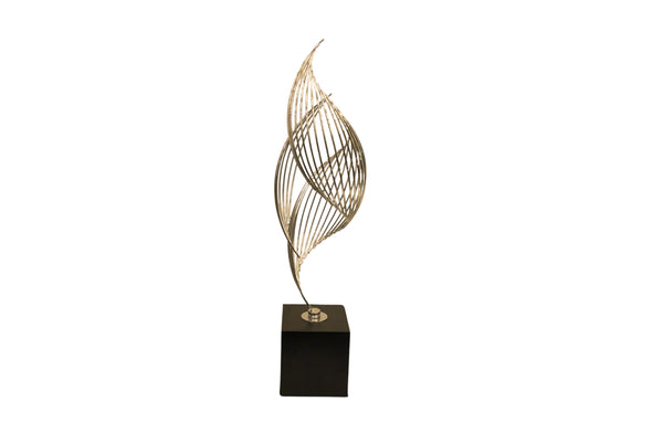 Medium gold Ribbon Table Décor with black base – modern and flowing in design, ideal for shelf or table styling.