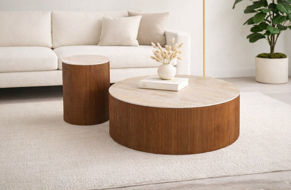 Walnut round coffee and side tables styled in bright lounge creating warm inviting atmosphere
