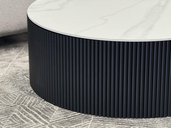 Ripple round black base coffee table with white marble top in modern living room