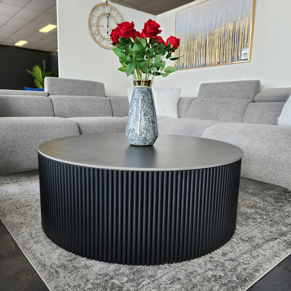 Ripple round black coffee table with ribbed design and black top