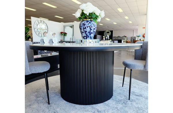 Ripple Round Dining Table with elegant marble top styled with blue vase and décor accents.